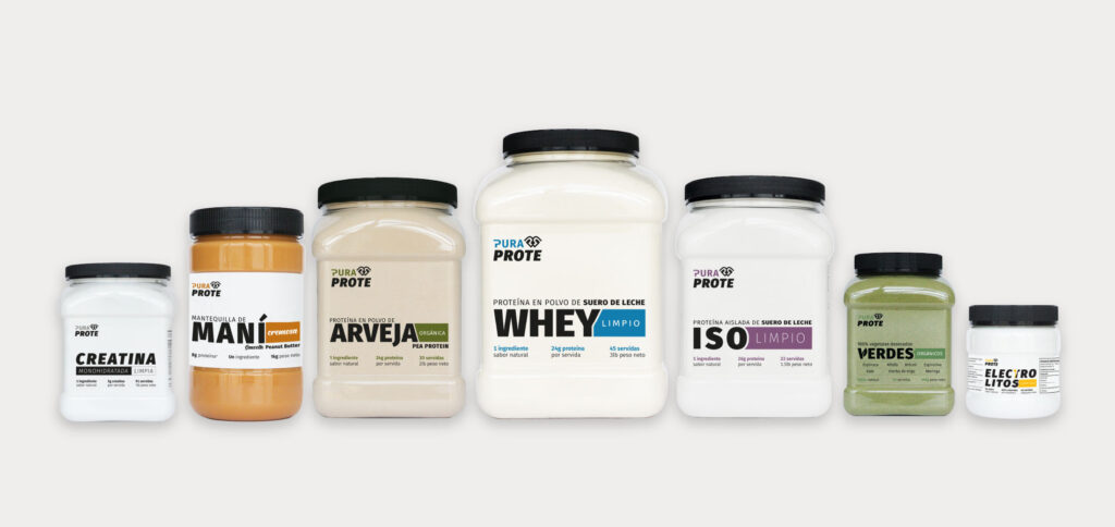 Row of PURA PROTE supplement jars in various flavors lined up on a white background.